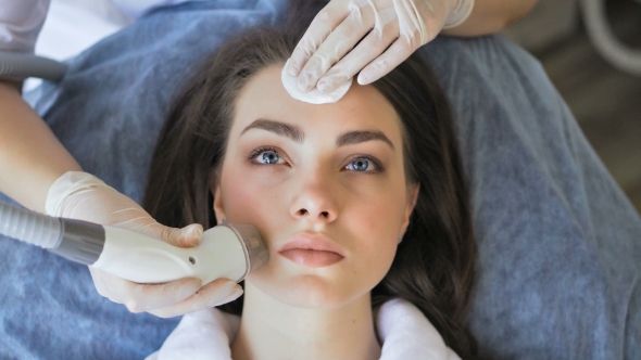 Young Woman Getting Radio Frequency Lifting Procedure in a Beauty Salon alt