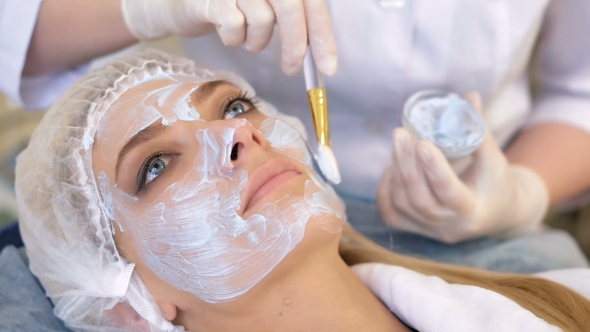 Beautiful Woman with Facial Mask at Beauty Salon alt