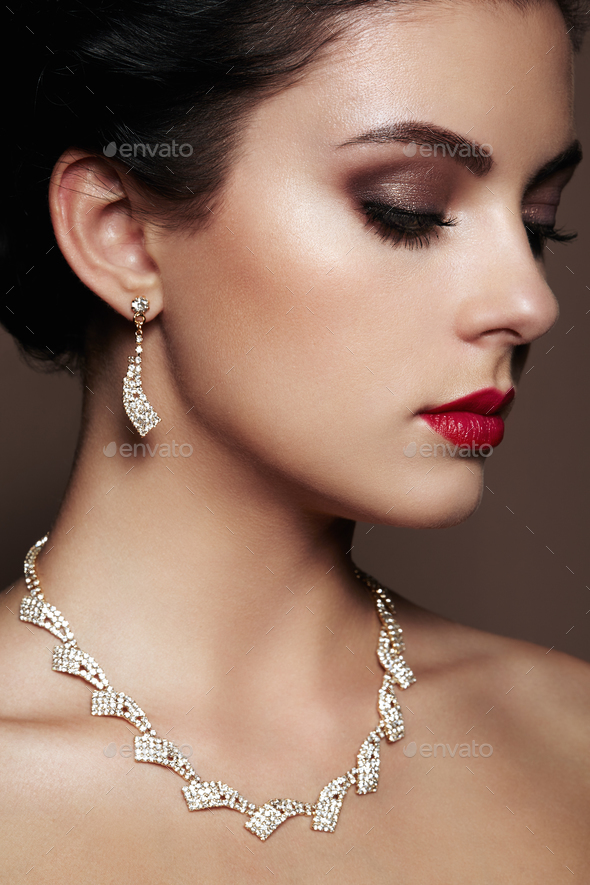 Fashion portrait of young beautiful woman with jewelry. - Stock Photo - Images