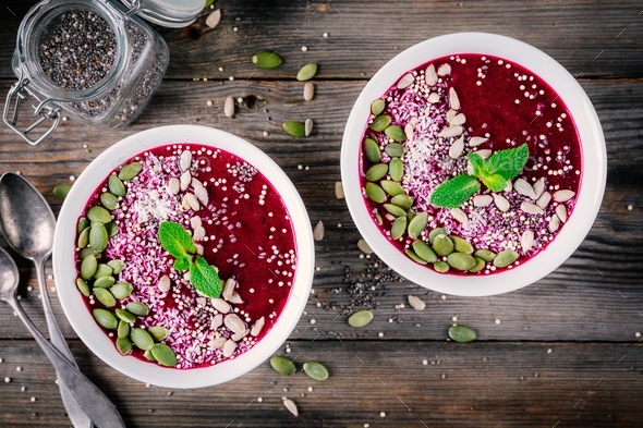Acai smoothie bowl with chia seeds, coconut, pumpkin seeds, quinoa, sunflower seeds and mint - Stock Photo - Images
