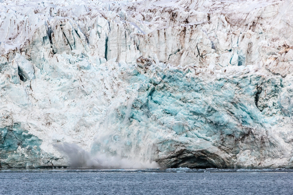 Calving ice of a massive glacier at Svalbard - Stock Photo - Images