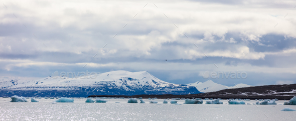 Panorama of floating sea ice in front of snowy mountains in the arctic - Stock Photo - Images