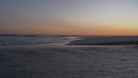 Senior Couple Walking Along Coast.