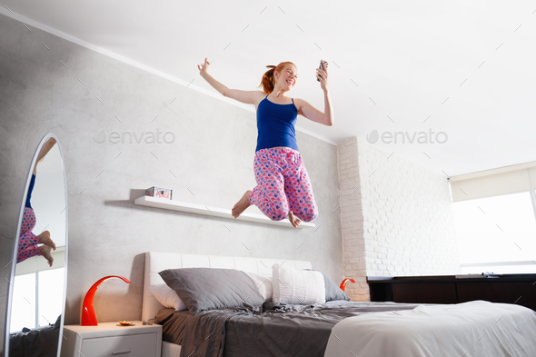 Good News For Happy Young Woman Girl Jumping On Bed