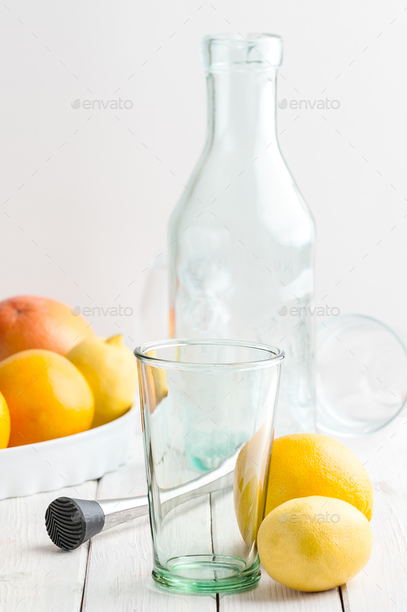 a set for making lemonade on a white wooden table making lemonade