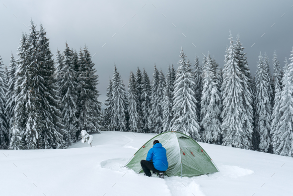 Green tent in winter mountains - Stock Photo - Images