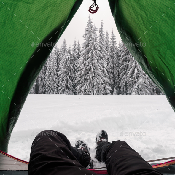 Green tent in winter mountains - Stock Photo - Images