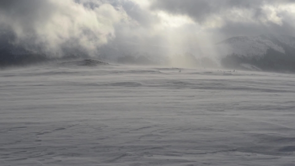 Snowstorm in Winter Mountains