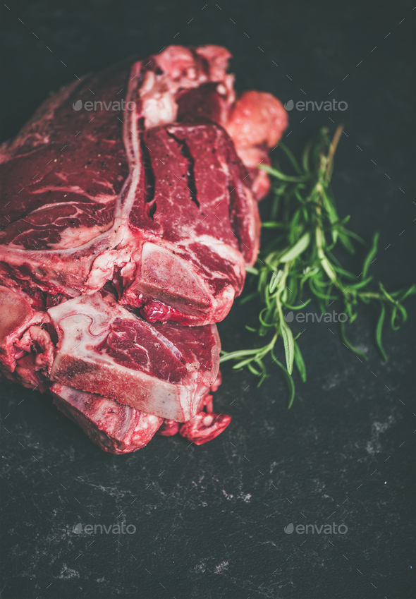 Raw beef meat t-bone steaks with rosemary, copy space - Stock Photo - Images