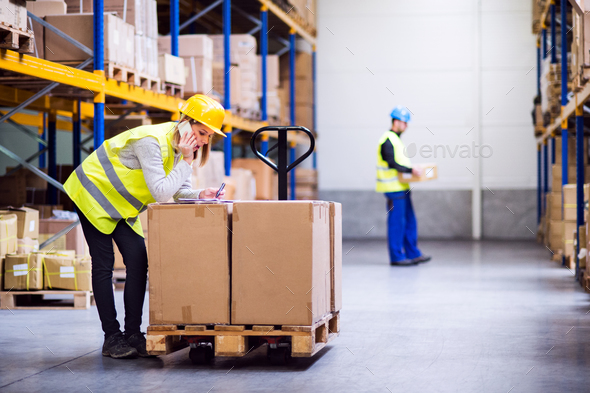 Young warehouse workers with smartphone. - Stock Photo - Images