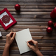 Human writing xmas wishes on blank paper sheet with holiday symbols near by - $5.00 Human writing xmas wishes on blank paper sheet with holiday symbols near by