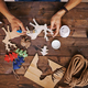 Craftsman painting wooden deers with white gouache - $5.00 Craftsman painting wooden deers with white gouache