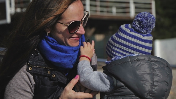 Young Mother and Little Child, Her Son Playing in Winter Clothes