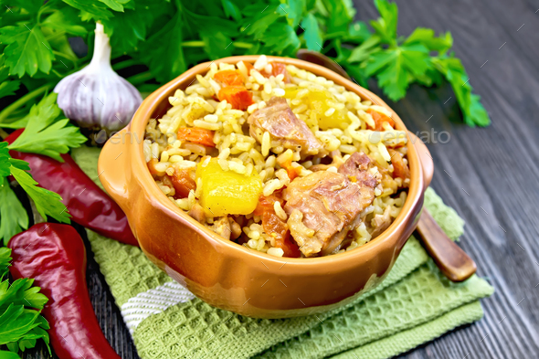 Rice with chicken and zucchini in bowl on board - Stock Photo - Images