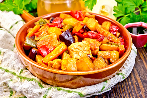 Roast with vegetables and honey in pan on dark board - Stock Photo - Images