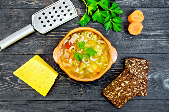 Soup Minestrone in clay bowl on black board top - Stock Photo - Images
