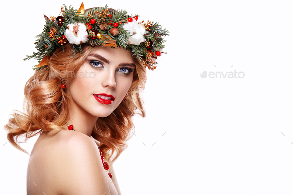 Portrait of beautiful young woman with Christmas wreath - Stock Photo - Images