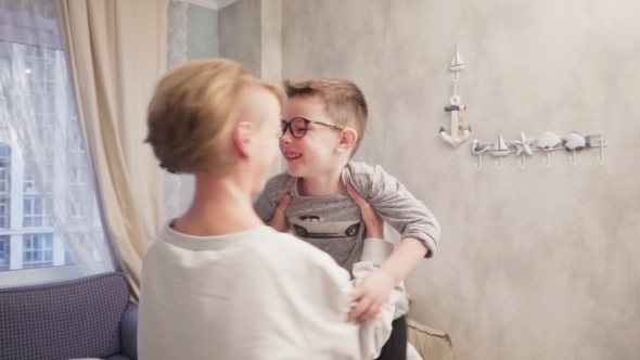 Happy Mother Hugs Her Son and Dances with Him