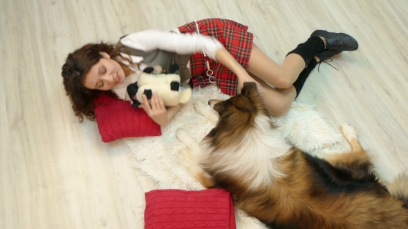 The Girl with the Dog Is Lying on the Floor