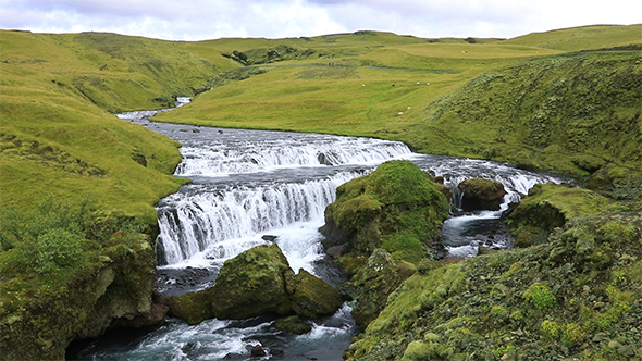 River Flowing Into The Waterfall Skogafoss in Iceland
