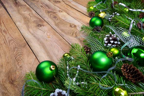 Christmas garland with green baubles on the rustic wooden backgr - Stock Photo - Images