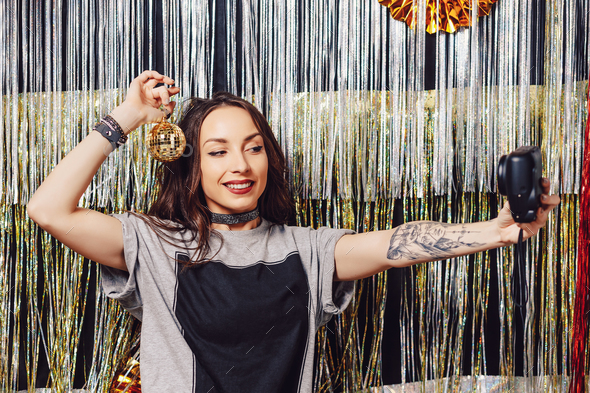 Smiling girl taking a selfie while partying - Stock Photo - Images
