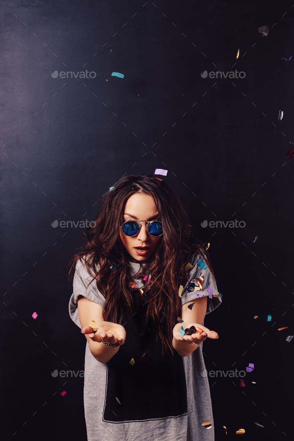 Surprised girl with confetti in hands - Stock Photo - Images