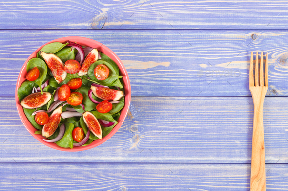 Fresh prepared fruit and vegetable salad with wooden fork - Stock Photo - Images