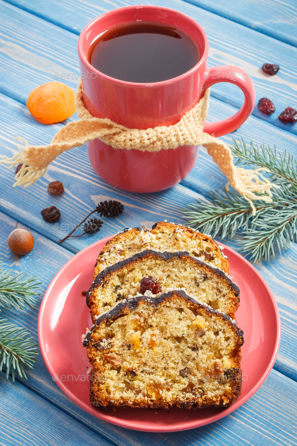 Cup of hot tea, fresh baked fruitcake for Christmas time and spruce branches - Stock Photo - Images