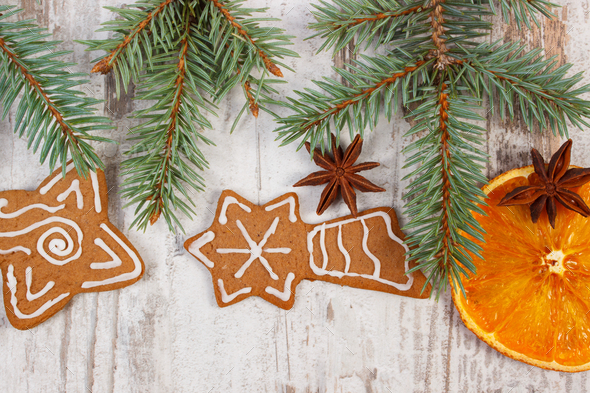 Fresh baked gingerbread, spruce branches and spices on old board, christmas decoration - Stock Photo - Images