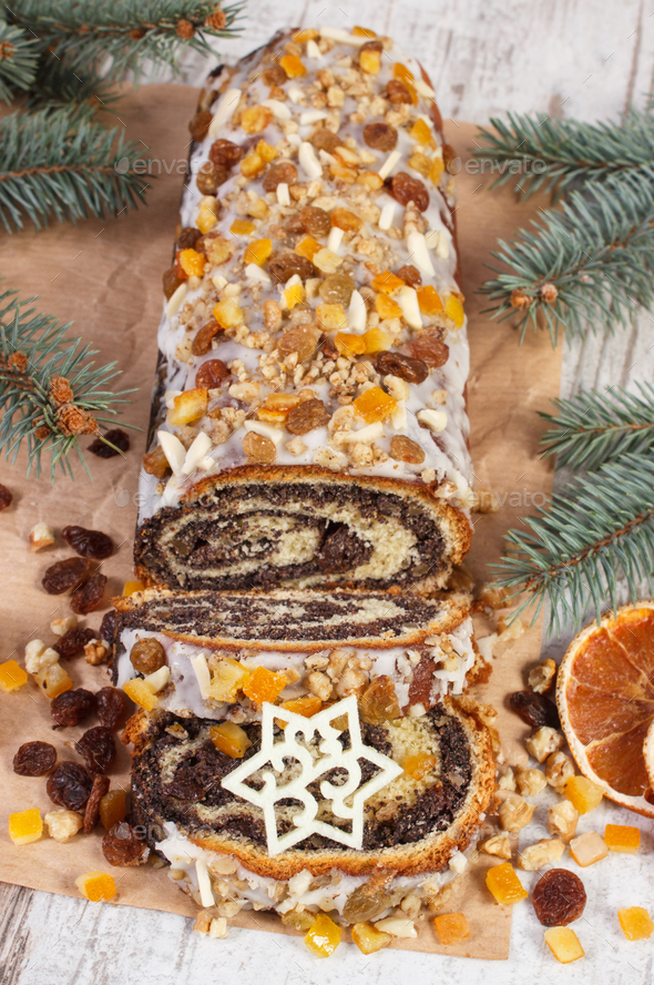 Homemade poppy seeds cake and spruce branches, dessert for festive Christmas time - Stock Photo - Images