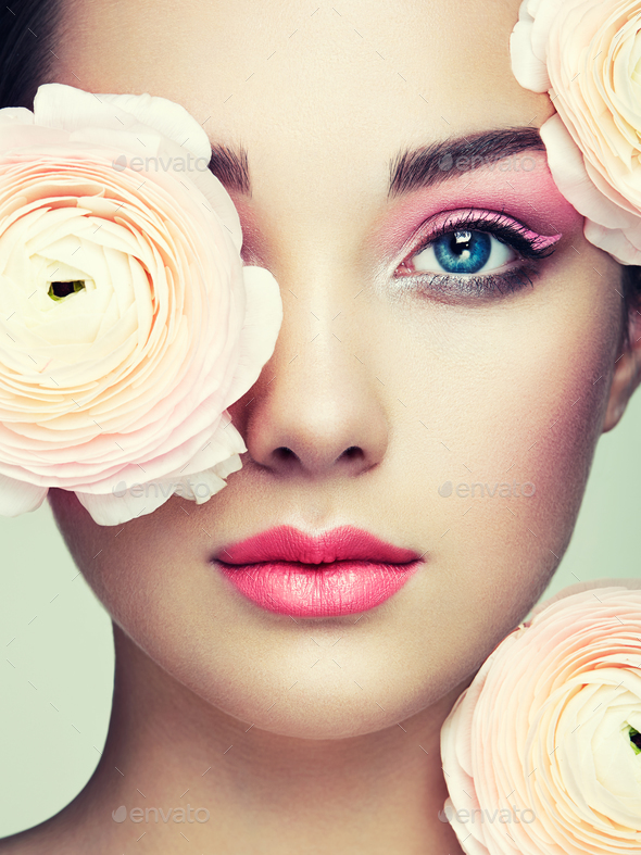 Portrait of beautiful young woman with flowers - Stock Photo - Images