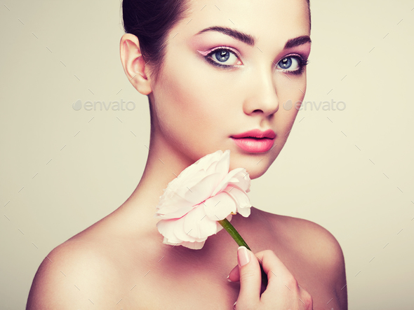 Portrait of beautiful young woman with flowers - Stock Photo - Images