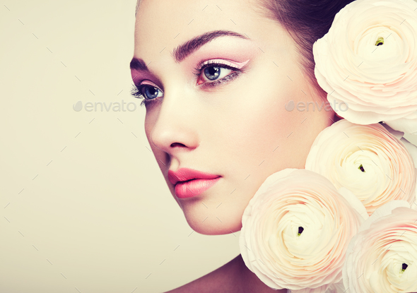 Portrait of beautiful young woman with flowers - Stock Photo - Images