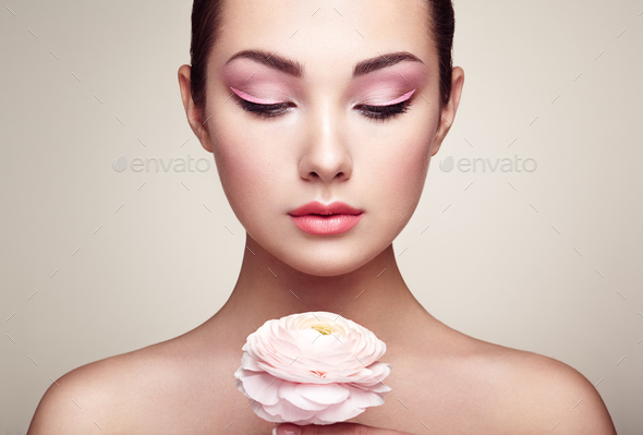 Portrait of beautiful young woman with flowers - Stock Photo - Images
