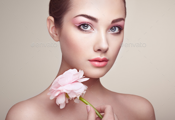 Portrait of beautiful young woman with flowers - Stock Photo - Images