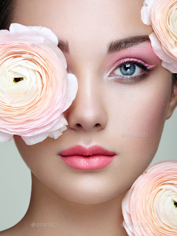 Portrait of beautiful young woman with flowers - Stock Photo - Images