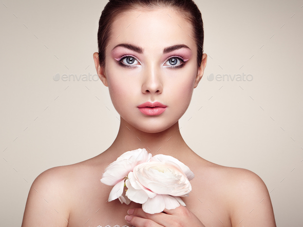 Portrait of beautiful young woman with flowers - Stock Photo - Images