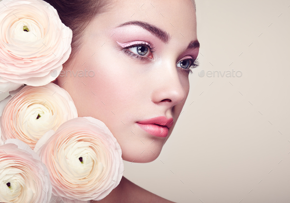 Portrait of beautiful young woman with flowers - Stock Photo - Images