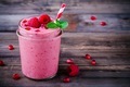 Pink pomegranate smoothie in a glass jar with mint and fresh raspberries - PhotoDune Item for Sale