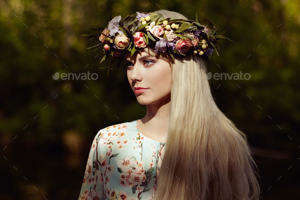 Beautiful blonde woman with flower wreath on her head - Stock Photo - Images