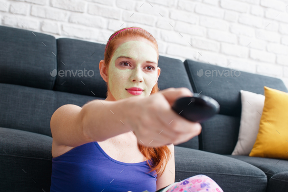 Girl With Beauty Mask Watching Television At Home - Stock Photo - Images
