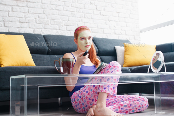 Girl With Beauty Mask Reading And Watching Television At Home - Stock Photo - Images