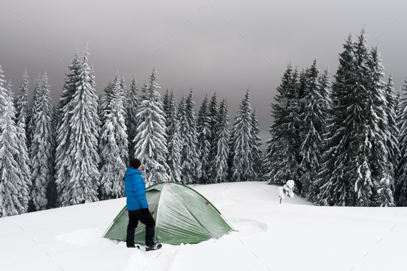 Green tent in winter mountains - Stock Photo - Images