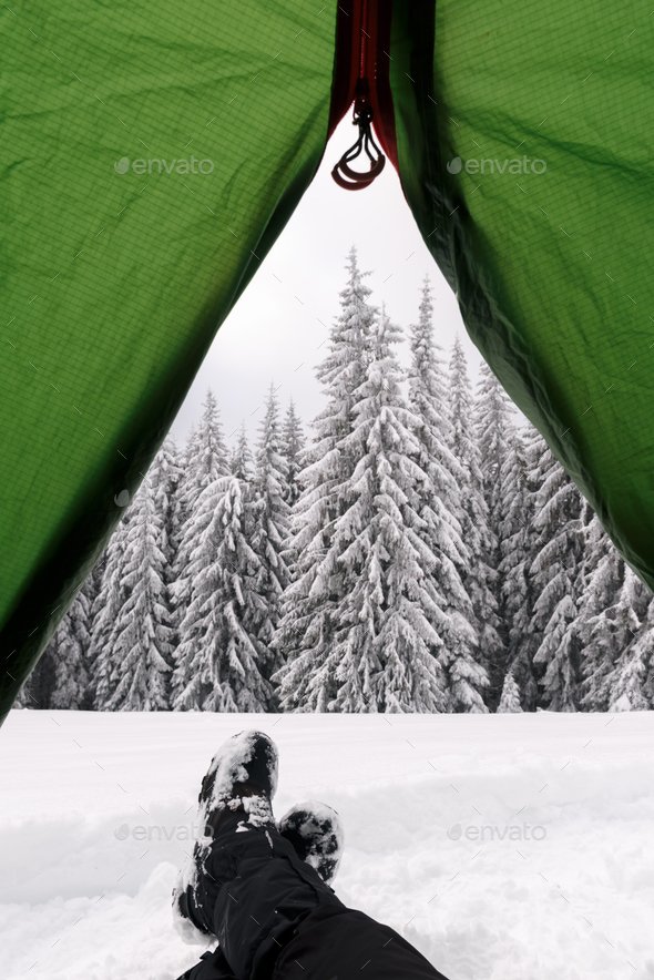 Green tent in winter mountains - Stock Photo - Images