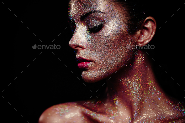 Portrait of beautiful woman with sparkles on her face - Stock Photo - Images