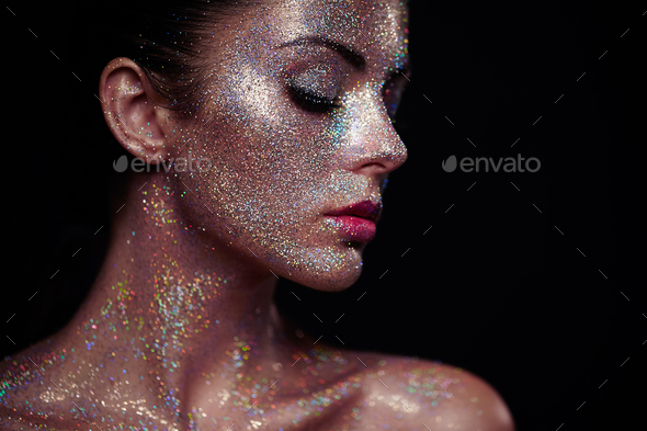 Portrait of beautiful woman with sparkles on her face - Stock Photo - Images