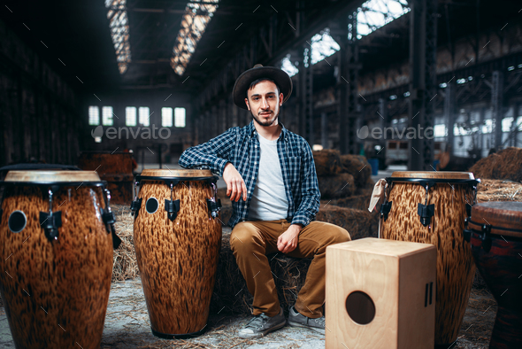 Male drummer pose against african wooden drum - Stock Photo - Images