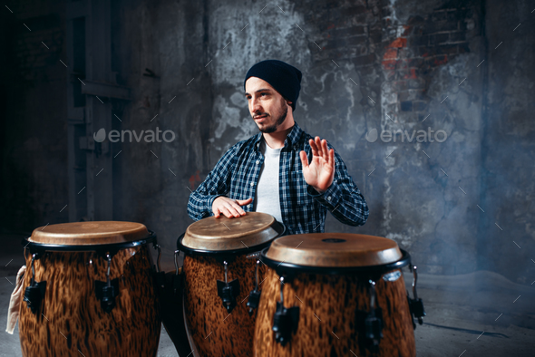 Drummer playing on wooden bongo drums, beat rhythm