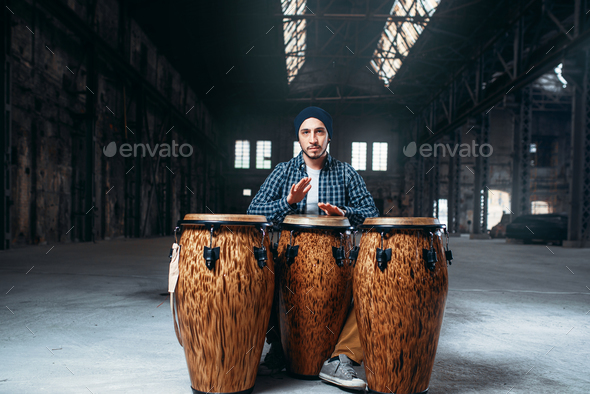 Male drummer plays on wooden drum - Stock Photo - Images